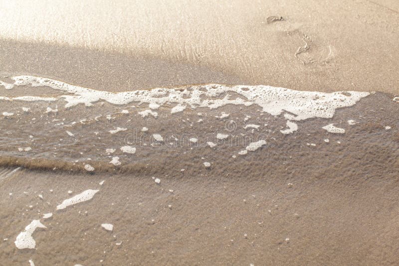 Textured wet sand beach background. 