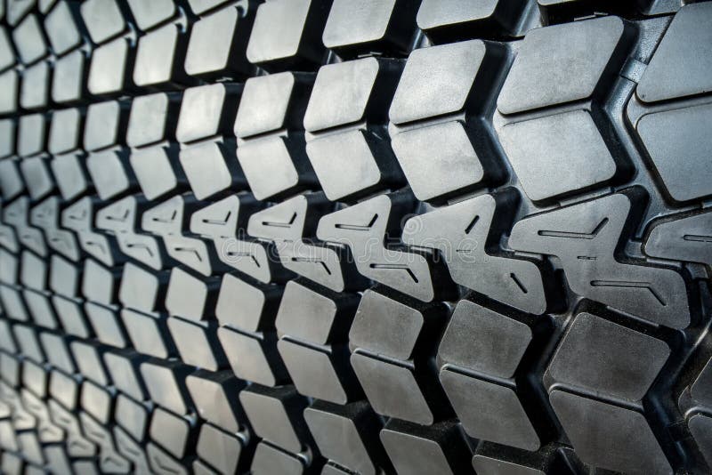 Photo coarse textured black tire tread large truck close-up. Photo coarse textured black tire tread large truck close-up.