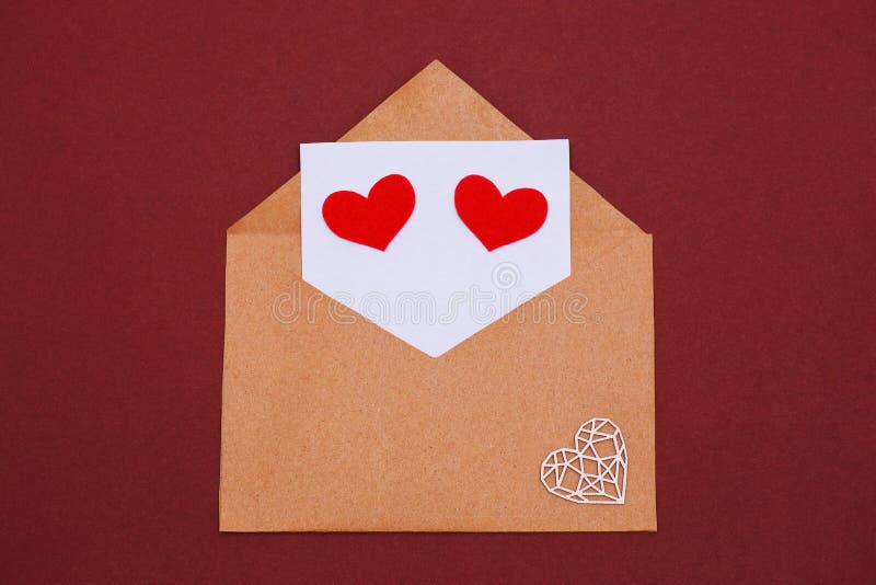 The 14th of February. Valentine`s Day. Kraft paper envelope with a letter and eyes in the shape of hearts royalty free stock photography The 14th of February. Valentine`s Day. Kraft paper envelope with a letter and eyes in the shape of hearts royalty free stock photography