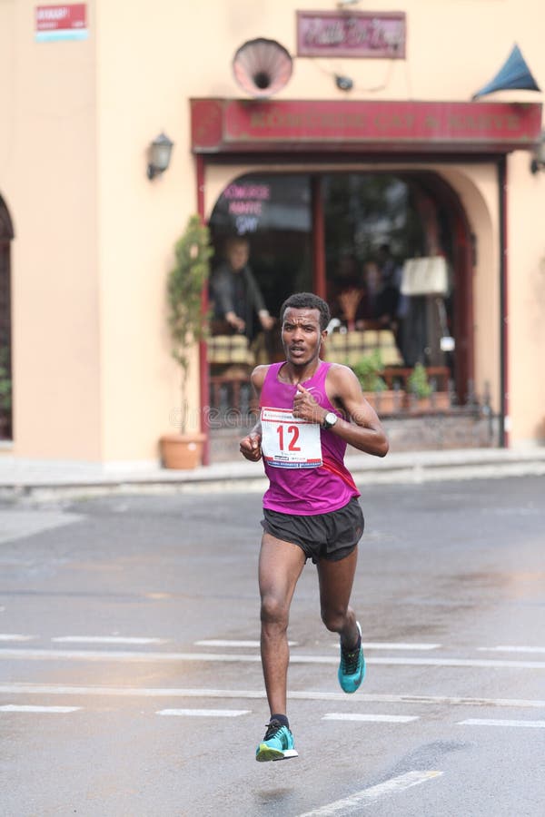 ISTANBUL, TURKEY - APRIL 26, 2015: Athlete is running in Old Town streets of Istanbul during Vodafone 10th Istanbul Half Marathon. ISTANBUL, TURKEY - APRIL 26, 2015: Athlete is running in Old Town streets of Istanbul during Vodafone 10th Istanbul Half Marathon