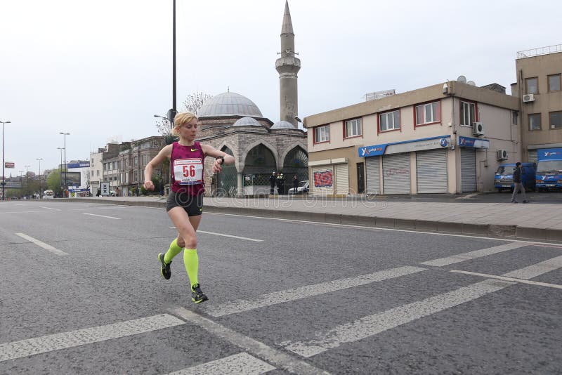 ISTANBUL, TURKEY - APRIL 26, 2015: Athlete is running in Old Town streets of Istanbul during Vodafone 10th Istanbul Half Marathon. ISTANBUL, TURKEY - APRIL 26, 2015: Athlete is running in Old Town streets of Istanbul during Vodafone 10th Istanbul Half Marathon