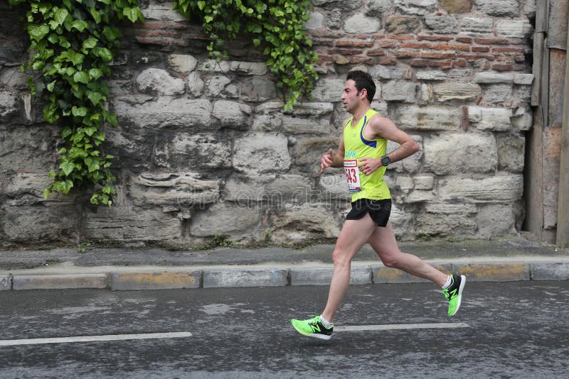 ISTANBUL, TURKEY - APRIL 26, 2015: Athlete is running in Old Town streets of Istanbul during Vodafone 10th Istanbul Half Marathon. ISTANBUL, TURKEY - APRIL 26, 2015: Athlete is running in Old Town streets of Istanbul during Vodafone 10th Istanbul Half Marathon