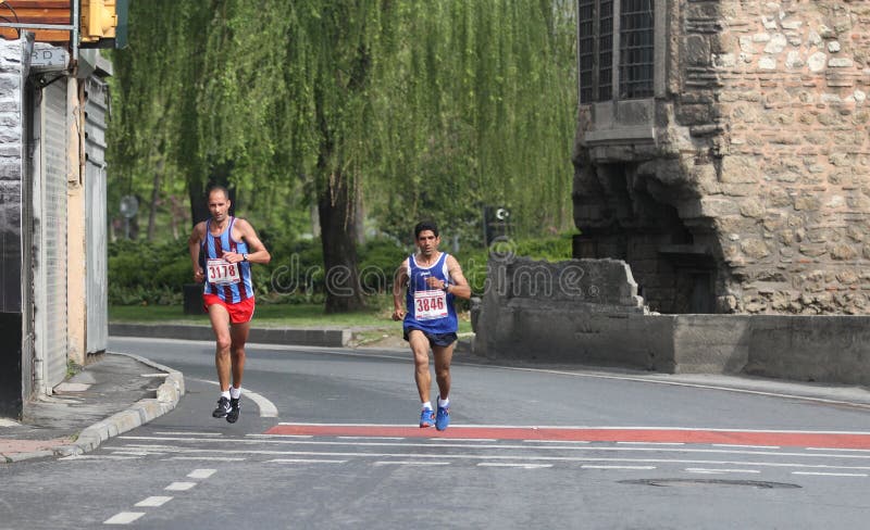 ISTANBUL, TURKEY - APRIL 26, 2015: Athletes are running in Old Town streets of Istanbul during Vodafone 10th Istanbul Half Marathon. ISTANBUL, TURKEY - APRIL 26, 2015: Athletes are running in Old Town streets of Istanbul during Vodafone 10th Istanbul Half Marathon