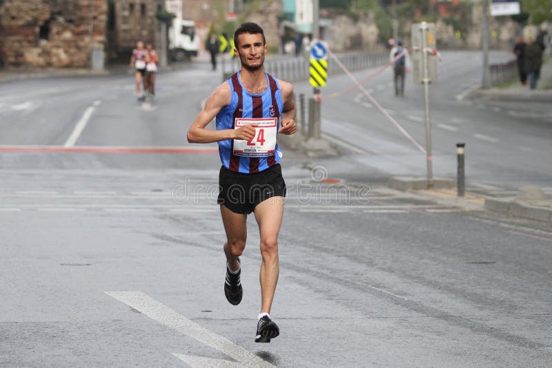 ISTANBUL, TURKEY - APRIL 26, 2015: Athlete is running in Old Town streets of Istanbul during Vodafone 10th Istanbul Half Marathon. ISTANBUL, TURKEY - APRIL 26, 2015: Athlete is running in Old Town streets of Istanbul during Vodafone 10th Istanbul Half Marathon