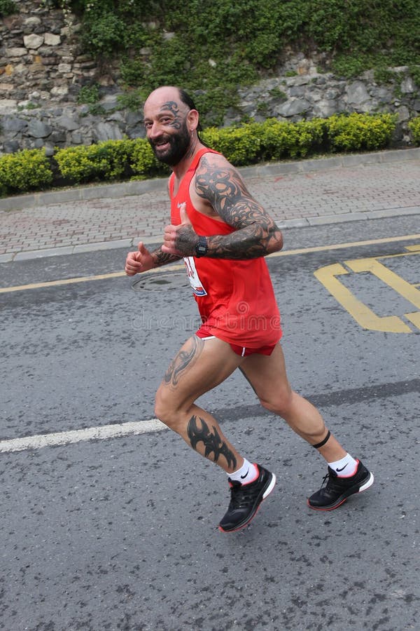 ISTANBUL, TURKEY - APRIL 26, 2015: Athlete is running in Old Town streets of Istanbul during Vodafone 10th Istanbul Half Marathon. ISTANBUL, TURKEY - APRIL 26, 2015: Athlete is running in Old Town streets of Istanbul during Vodafone 10th Istanbul Half Marathon