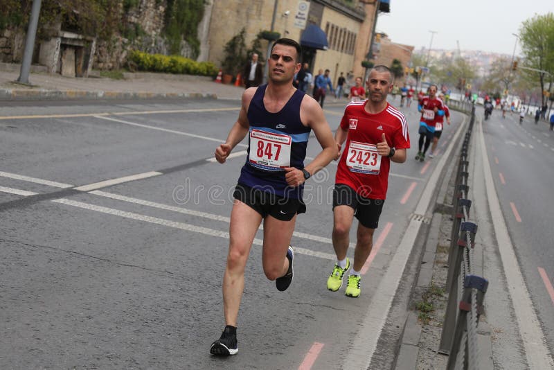 ISTANBUL, TURKEY - APRIL 26, 2015: Athletes are running in Old Town streets of Istanbul during Vodafone 10th Istanbul Half Marathon. ISTANBUL, TURKEY - APRIL 26, 2015: Athletes are running in Old Town streets of Istanbul during Vodafone 10th Istanbul Half Marathon