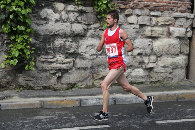 ISTANBUL, TURKEY - APRIL 26, 2015: Athlete is running in Old Town streets of Istanbul during Vodafone 10th Istanbul Half Marathon. ISTANBUL, TURKEY - APRIL 26, 2015: Athlete is running in Old Town streets of Istanbul during Vodafone 10th Istanbul Half Marathon