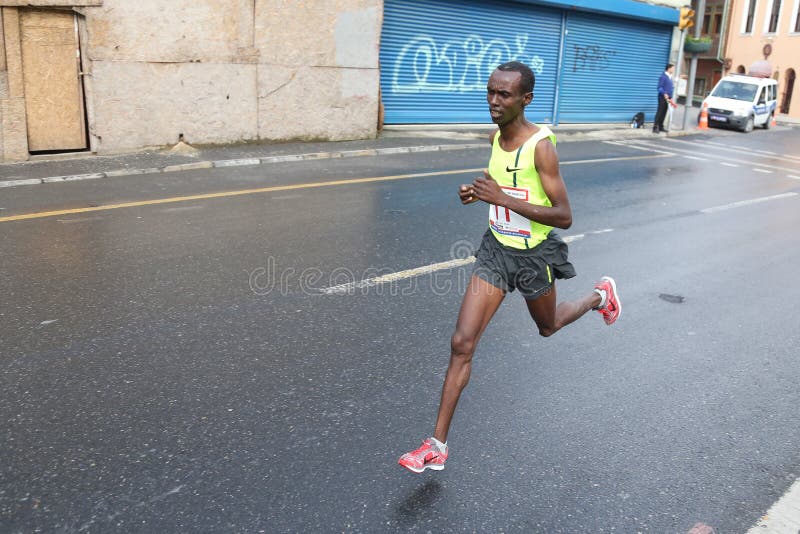 ISTANBUL, TURKEY - APRIL 26, 2015: Athlete is running in Old Town streets of Istanbul during Vodafone 10th Istanbul Half Marathon. ISTANBUL, TURKEY - APRIL 26, 2015: Athlete is running in Old Town streets of Istanbul during Vodafone 10th Istanbul Half Marathon