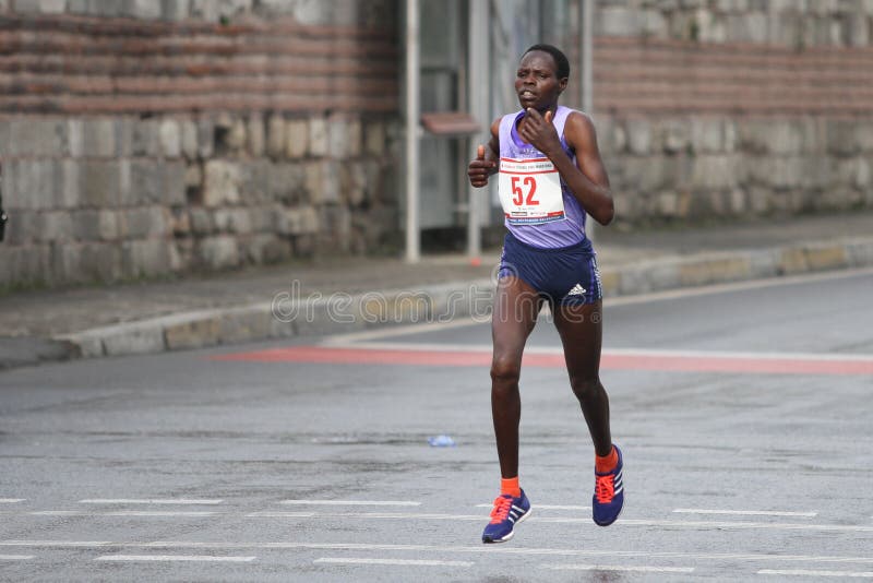 ISTANBUL, TURKEY - APRIL 26, 2015: Athlete is running in Old Town streets of Istanbul during Vodafone 10th Istanbul Half Marathon. ISTANBUL, TURKEY - APRIL 26, 2015: Athlete is running in Old Town streets of Istanbul during Vodafone 10th Istanbul Half Marathon