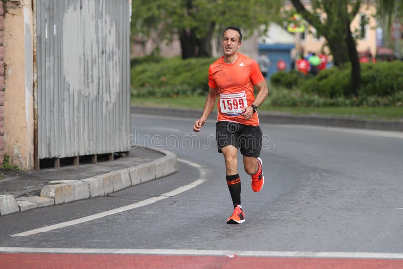 ISTANBUL, TURKEY - APRIL 26, 2015: Athlete is running in Old Town streets of Istanbul during Vodafone 10th Istanbul Half Marathon. ISTANBUL, TURKEY - APRIL 26, 2015: Athlete is running in Old Town streets of Istanbul during Vodafone 10th Istanbul Half Marathon