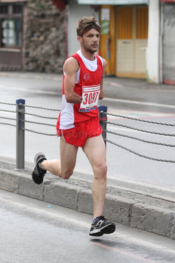 ISTANBUL, TURKEY - APRIL 26, 2015: Athlete is running in Old Town streets of Istanbul during Vodafone 10th Istanbul Half Marathon. ISTANBUL, TURKEY - APRIL 26, 2015: Athlete is running in Old Town streets of Istanbul during Vodafone 10th Istanbul Half Marathon