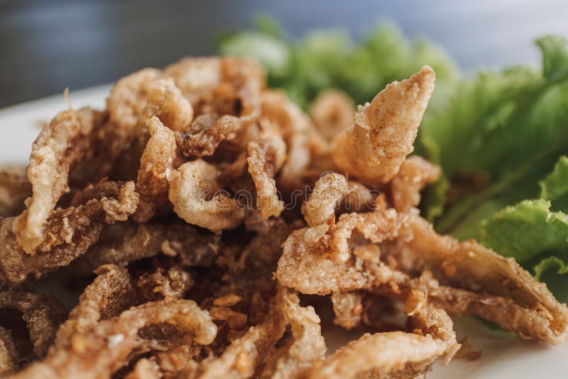 Thai Crispy Fish Served in White Dish Decorated with Vegetable. Stock