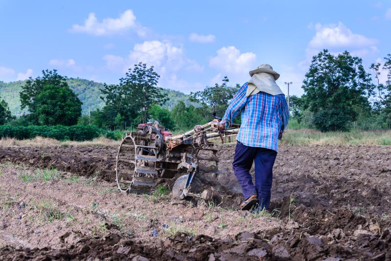 Thai farmer using walking tractors for cultivated soil for prepare plantation