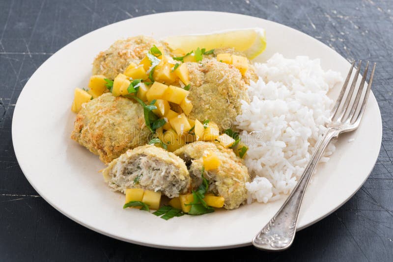 Thai fish cakes with mango salsa and white rice royalty free stock image Thai fish cakes with mango salsa and white rice royalty free stock image