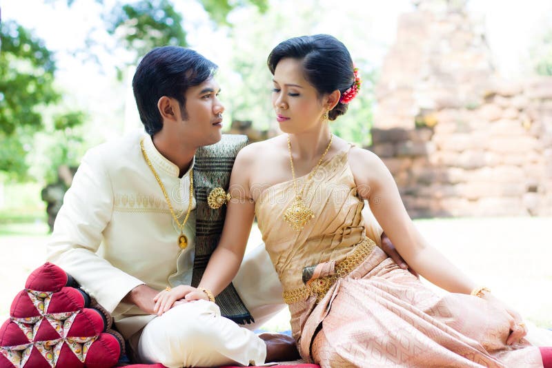 Thai men and women in silk dress stock photo.