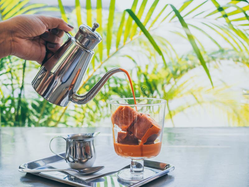 Thai milk tea ice cubes in glass