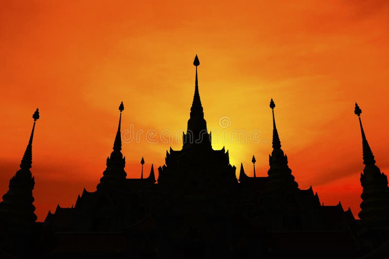 Thai pagoda at sunset, silhouette of pagoda