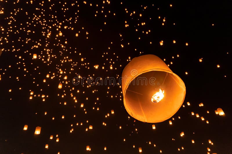 Thai people release sky floating lanterns or lamp to worship Buddha`s relics at night. Traditional festival in Chiang mai