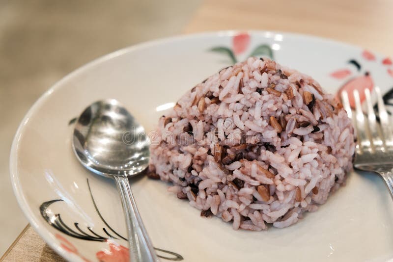 Thai Steam Brown Rice on White Plate in Thai Restaurant Stock Image