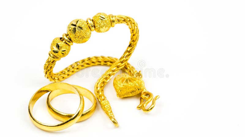 Thai style gold jewelry bracelet and couple gold ring isolated on white background with copy space
