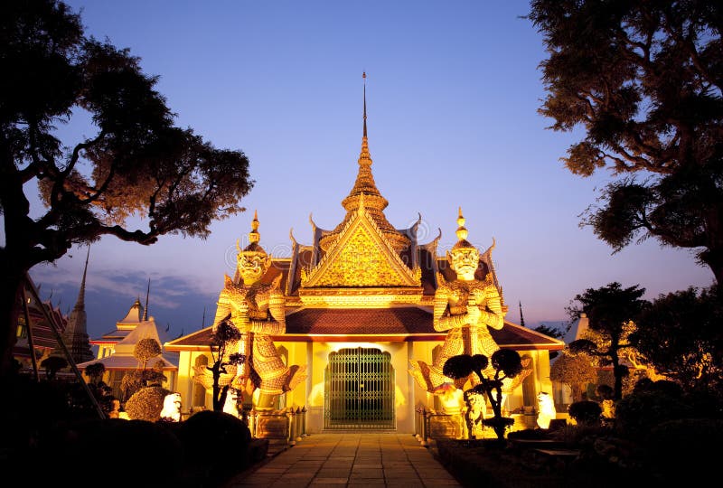 Thai temple glowing in golden light during sunset