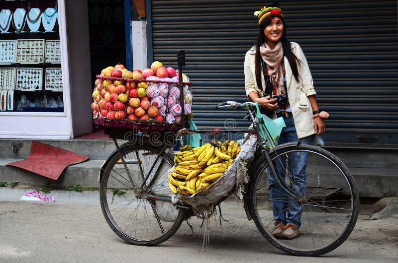 Thai women people travelers journey travel visit take photo with bicycle cart hawker of local life lifestyle nepali on road sale