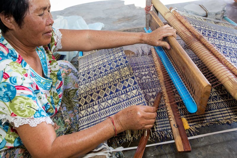 Thai woman weaving straw mat