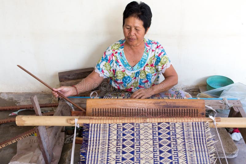 Thai woman weaving straw mat