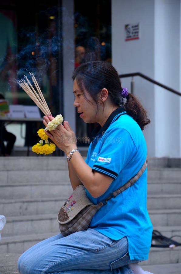 Thai woman worships and prays at outdoor shrine Bangkok Thailand stock images Thai woman worships and prays at outdoor shrine Bangkok Thailand stock images