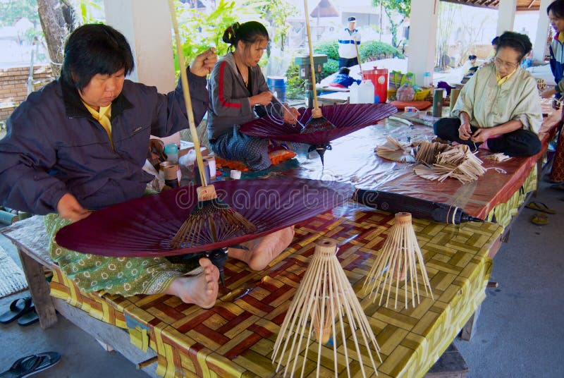 Thai women assemble traditional bamboo umbrella at the factory in Chiang Mai, Thailand.