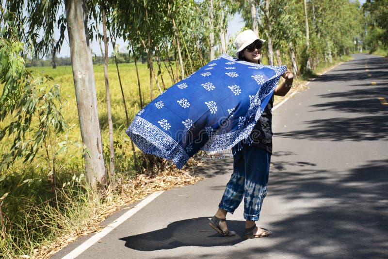 Thai Women Posing Relax And Playing Indigo Tie Dye Fabric Shawl On The Small Street In