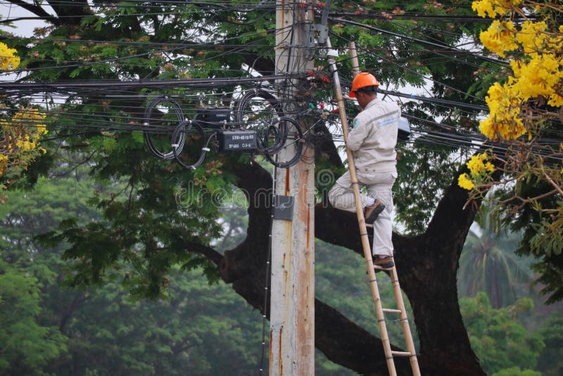 Thailand 1 April 2021 Electricians are climbing up to fix the light pole, transformer, electrical system and wires