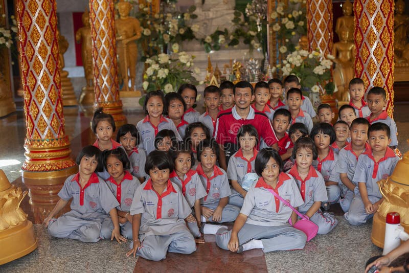 Thailand, Phuket, 01.18.2013. Elementary school students and a teacher in the Buddha temple, group photo. Education. Training. royalty free stock images Thailand, Phuket, 01.18.2013. Elementary school students and a teacher in the Buddha temple, group photo. Education. Training. royalty free stock images