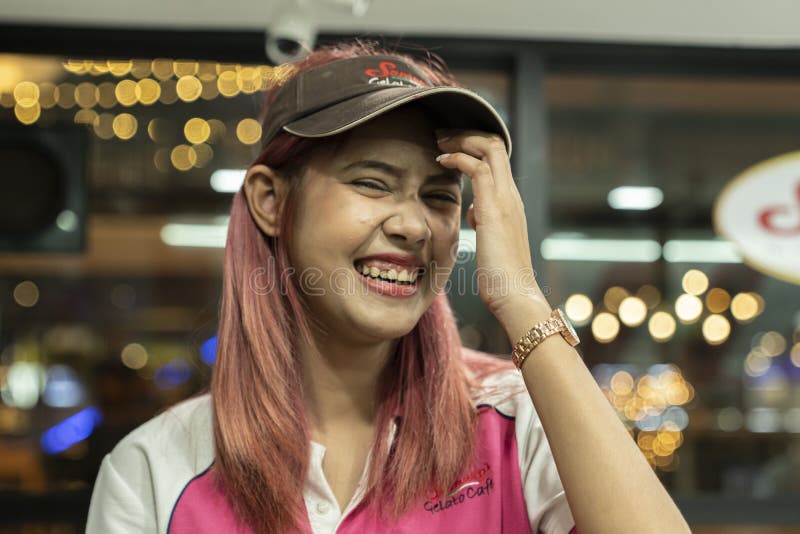 Thailand, Phuket, Patong, February 1, 2020: funny young Thai girl in a branded uniform, ice cream seller, close-up portrait on