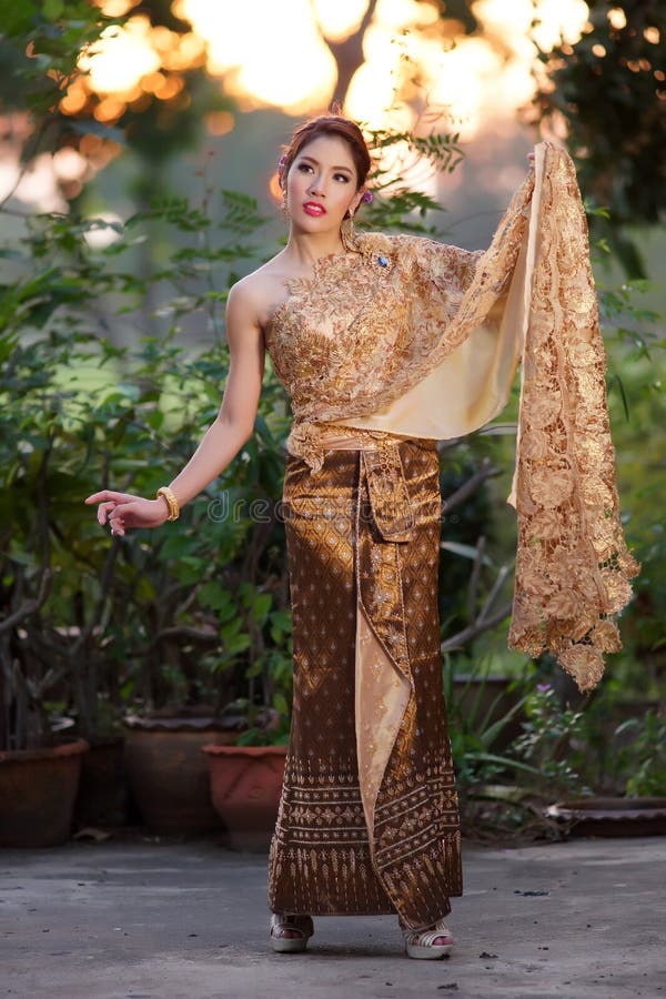Thailändsk kvinna som bär den typiska thailändska klänningen royaltyfri fotografi Thailändsk kvinna som bär den typiska thailändska klänningen royaltyfri fotografi