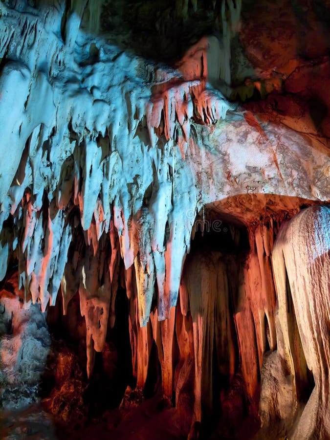 Stalactite wall illuminated with color light in Tham Khao Bin cave, Ratchaburi, Thailand