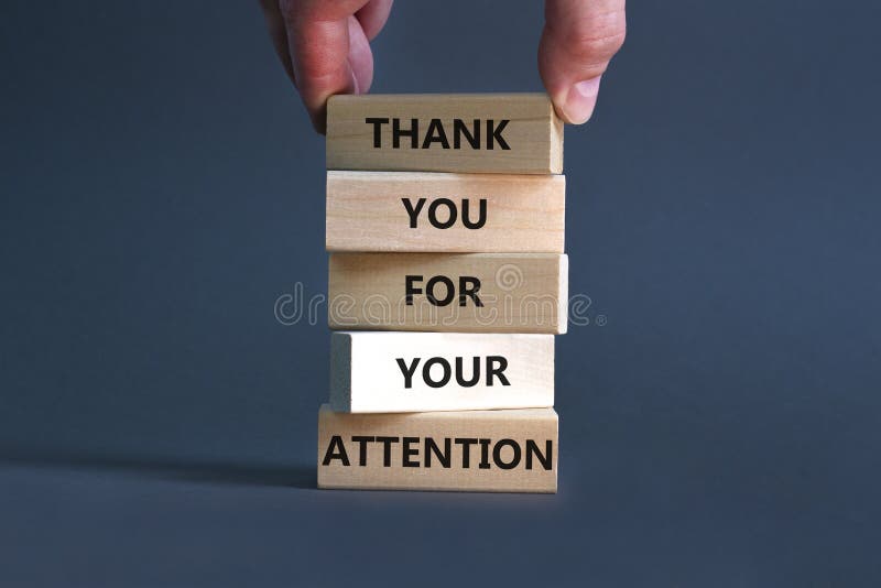 Thank you for attention symbol. Concept words Thank you for your attention on wooden blocks on a beautiful grey table grey. Background. Businessman hand