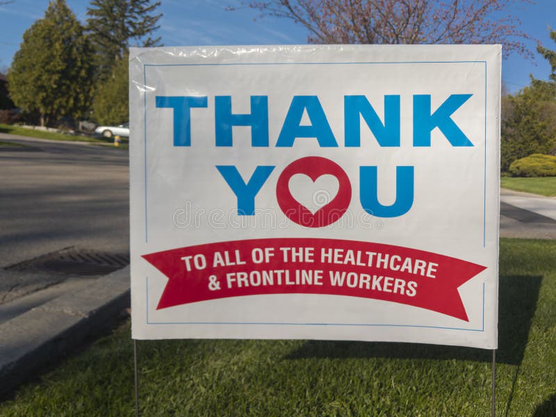 Thank you front line, essential workers & volunteers sign in front of a house during corona virus pandemic outbreak royalty free stock photo