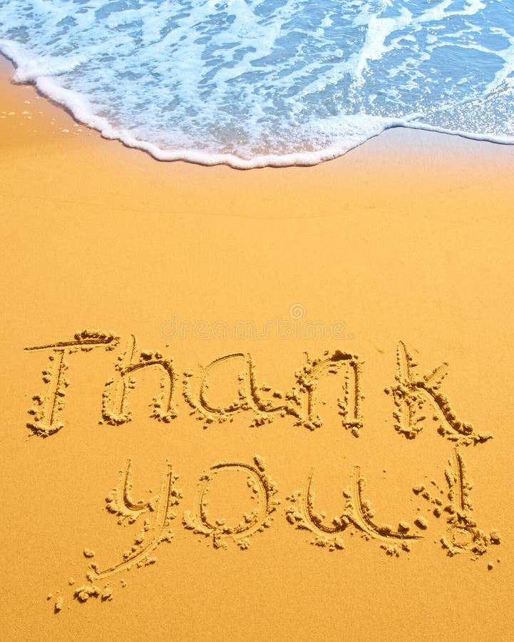 Thank you written in the sand on the beach