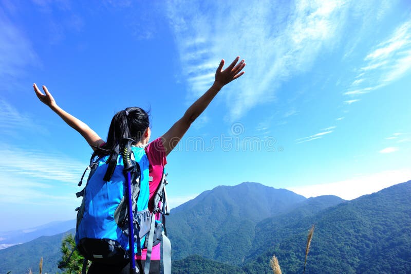 Thankful mountain climbing woman