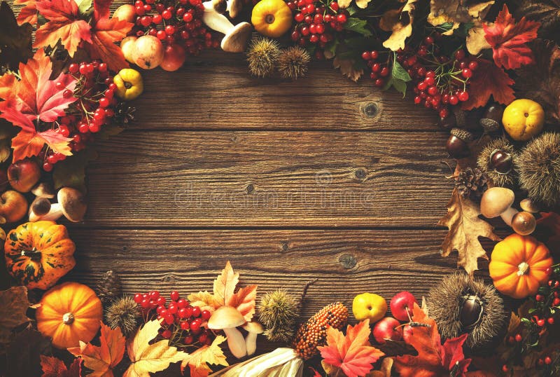 Vintage autumn border from fallen leaves and fruits on the old wooden table. Thanksgiving autumn background