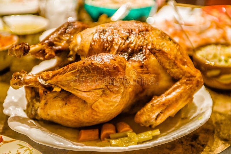 Thanksgiving baked turkey bird on the dinner table ready to eat