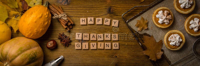 Thanksgiving concept - mini pumpkin pies on rustic wood background