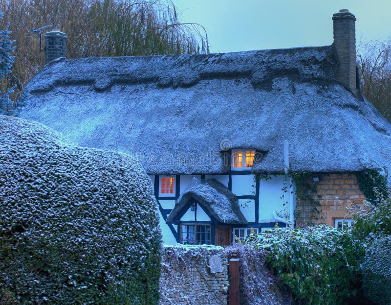 Thatched cottage with snow