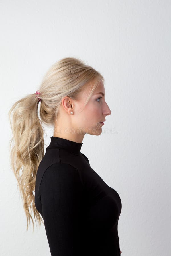 Portrait of a Blond Woman playing with her hair. 