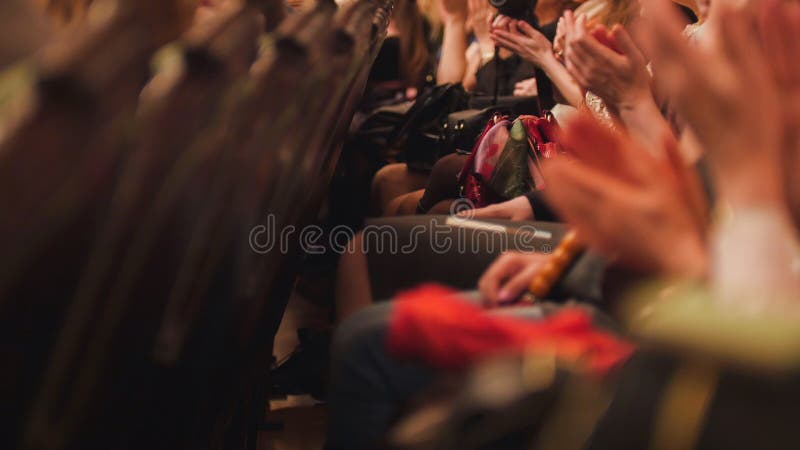 Theater hall - spectators is applauding the performance on stage