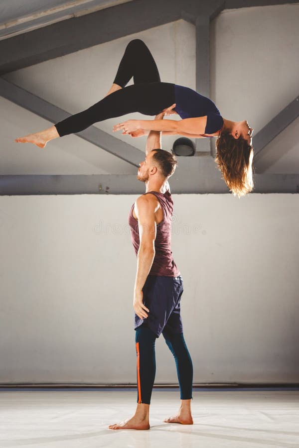 The Theme of Acroyoga and Yoga Poses. a Pair of Two Men and a Woman Stand  in the Position of Asana. the Guy Holds the Girl Arched Stock Photo - Image  of