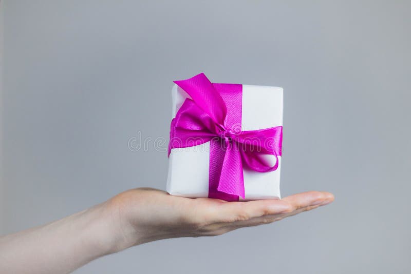 Theme of celebrations and gifts: woman holding exclusive gift Packed in white box with purple ribbon, beautiful and expensive gift stock photos Theme of celebrations and gifts: woman holding exclusive gift Packed in white box with purple ribbon, beautiful and expensive gift stock photos