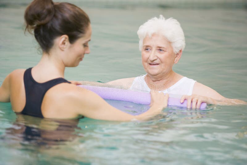 Therapist And Senior Patient In Hydrotherapy Pool. Therapist And Senior Patient In Hydrotherapy Pool