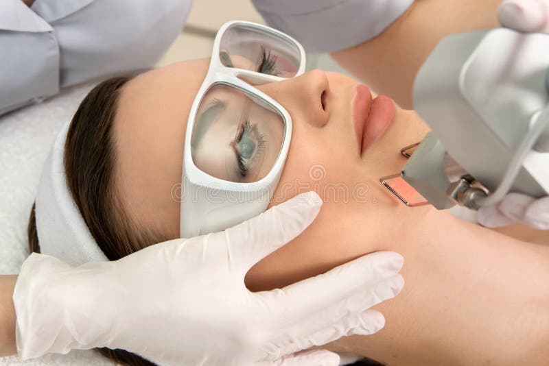 Therapist Beautician Makes A Laser Rejuvenation For The Model By Apparatus In A Beauty Salon